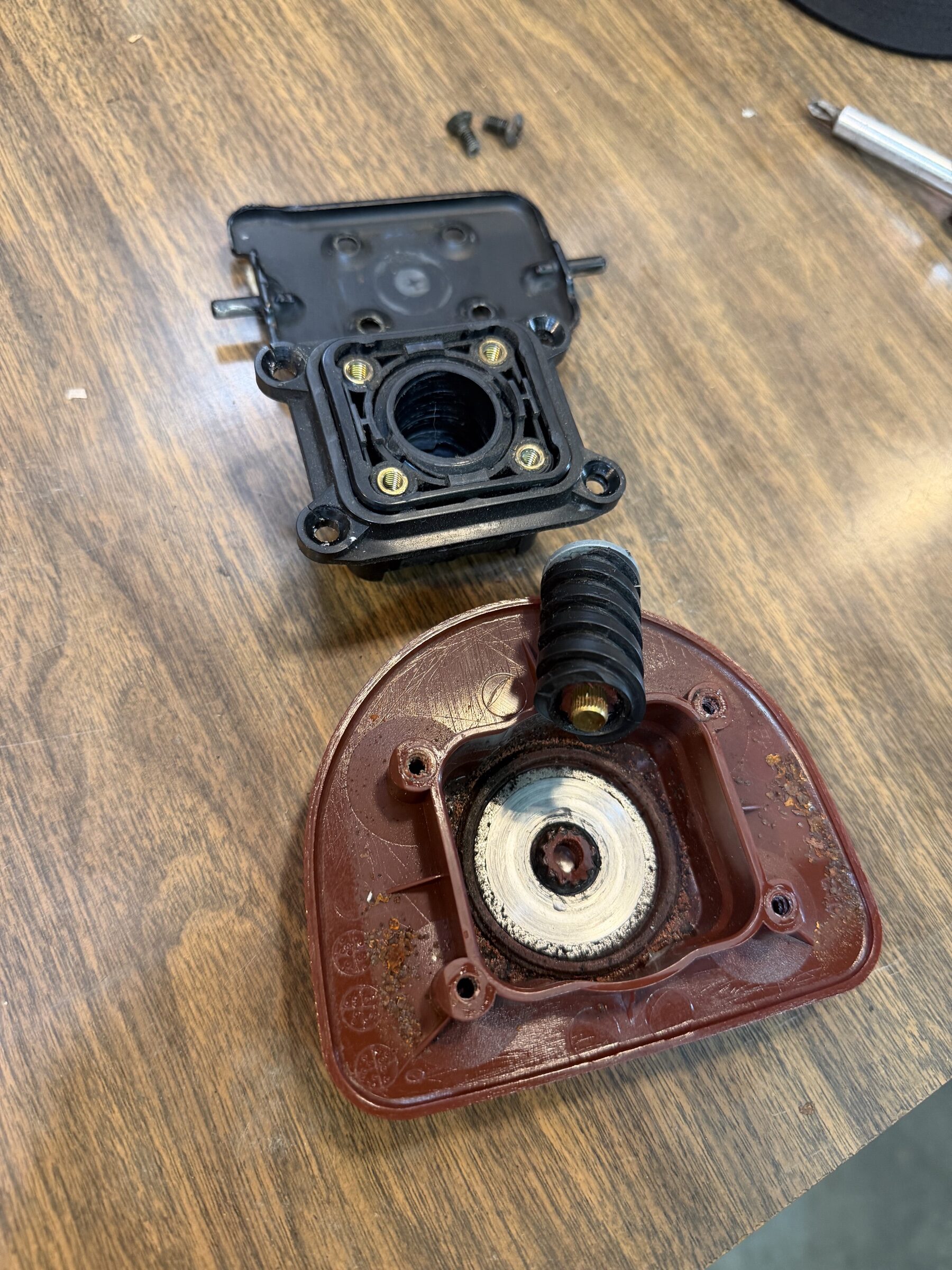 The broken sunroof knob assembly, disassembled on the bench