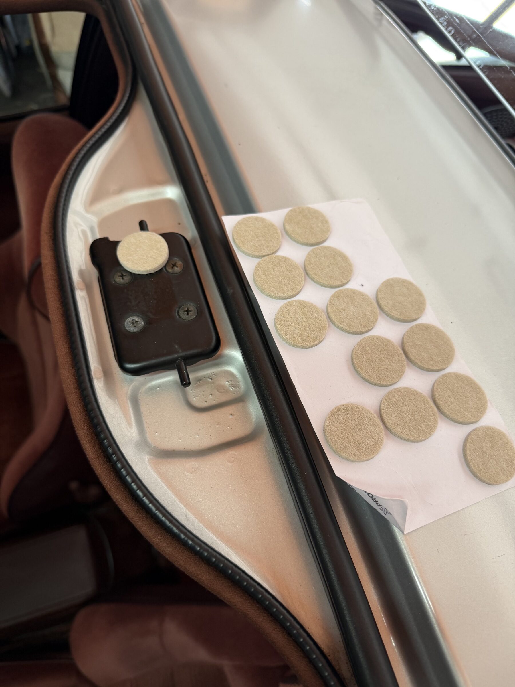 Sheet of adhesive felt pads next to the top seat